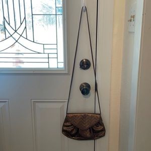 Neiman Marcus bronze/gold vinyl crossbody purse.